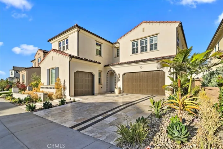 Driveway is paved with premium travertine tiles.