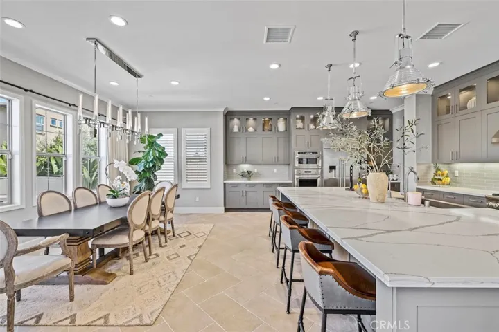 Dining area with lots of natural light and custom chandelier.