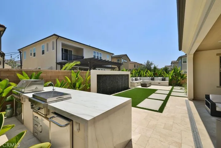 Backyard with BBQ island, waterfall, travertine floor