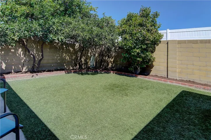 Private rear yard has multiple fruit trees.
