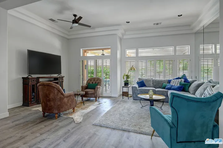 Open living room with remodeled floors. The home comes furnished in sun city, Palm Desert California