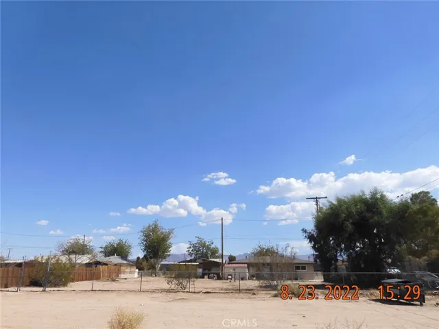 Looking at the lot from across the street.  This lot is 1 of 2 available lots that are in between the home on the left and the home on the right.