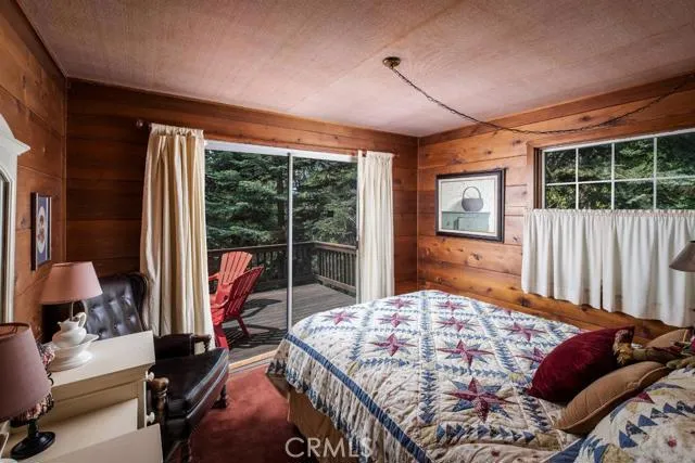 MAIN LEVEL BEDROOM WITH REAR DECK SLIDERS.