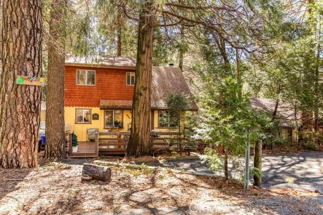 Front with near level lot with 2 car parking and extra parking to left of home.