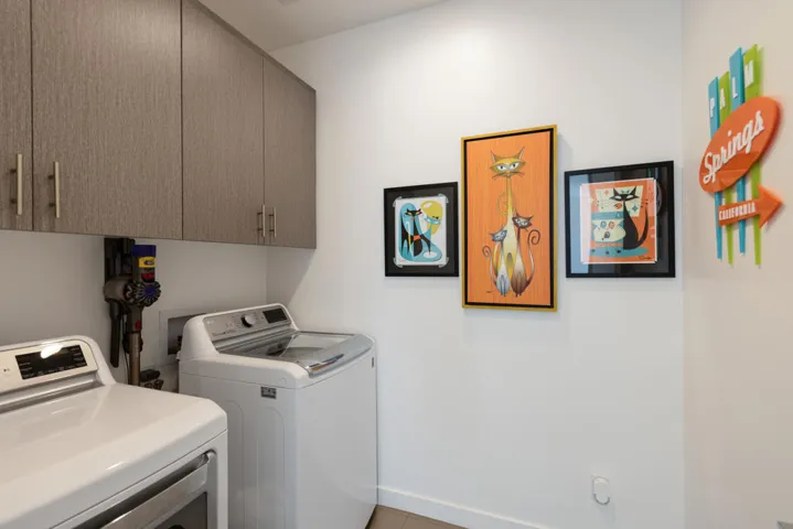 Inside Laundry with ample cabinets