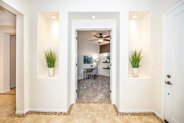 Entrance to the office/second bedroom with new carpet and ceiling fan.
