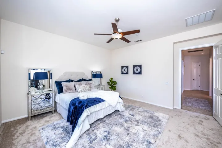 Master bedroom with new carpet and ceiling fan.