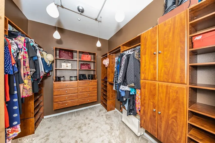 Master closet with new carpet and plenty of built in cupboards and drawers.