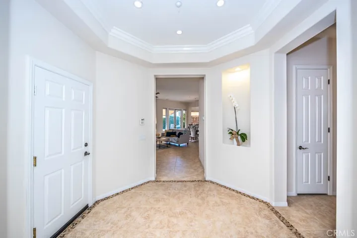 Hall entry way with direct garage access to the left, great room straight ahead, and bedrooms, bathrooms, and laundry to the right.