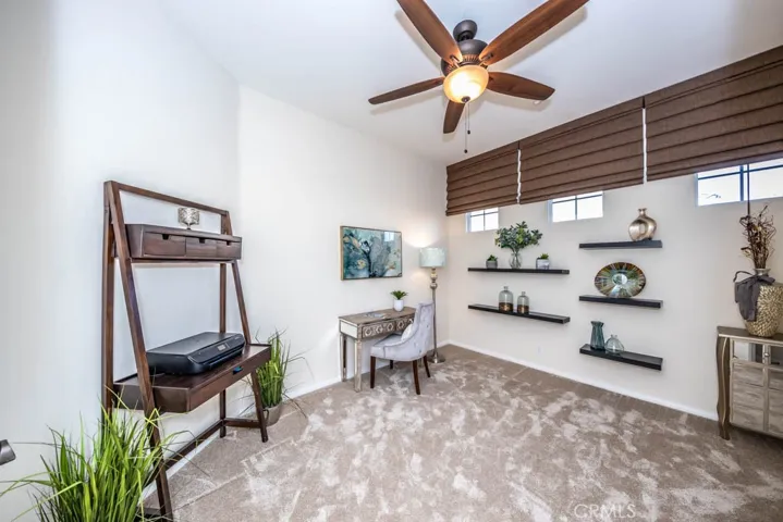 Office or bedroom with ceiling fan.