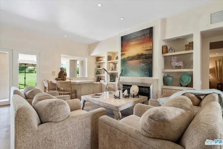 This half focuses on a tailored fireplace and sunken wet bar