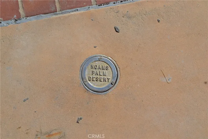 Plack in concrete by pool.