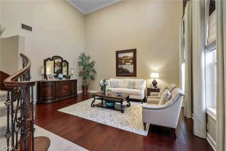 Large living room with cathedral ceiling, hardwood flooring.