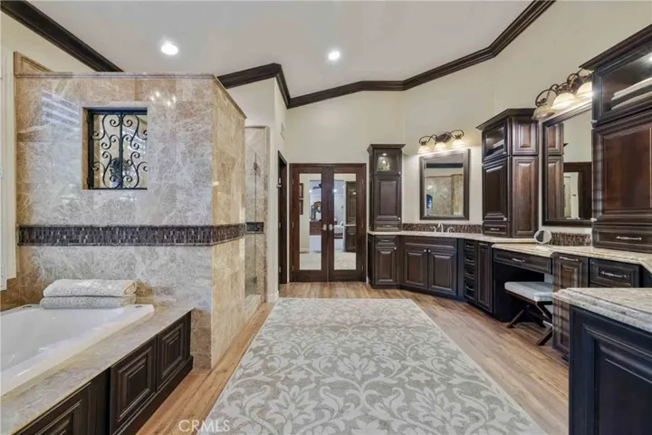 Master bathroom with his and hers vanities, Soaking jet bathtub and separate shower.