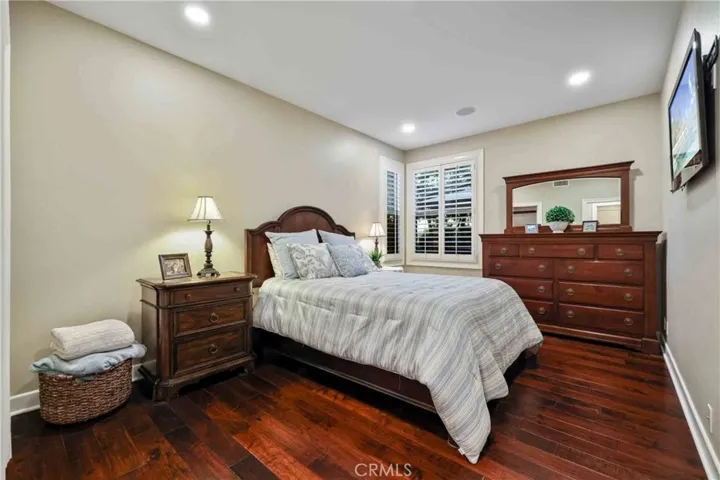 Bedroom downstairs with custom two-tone paint, recessed lights.