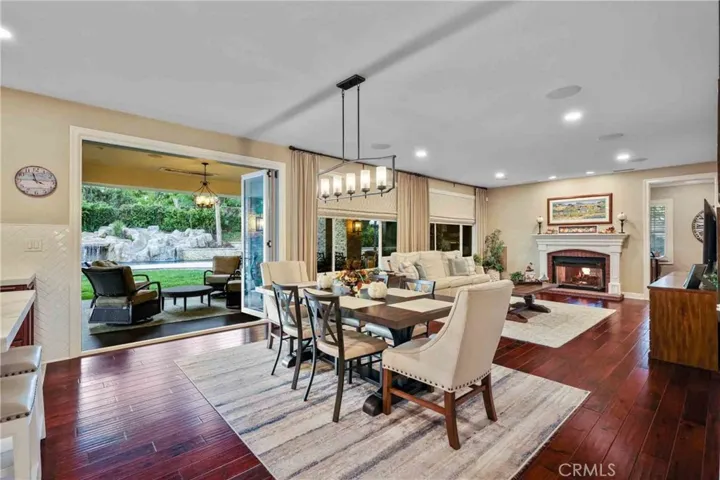 Super large family room with fireplace, with hardwood flooring.
