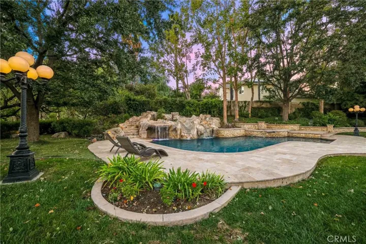Professionally landscaped gardens, lots of trees and flowers.