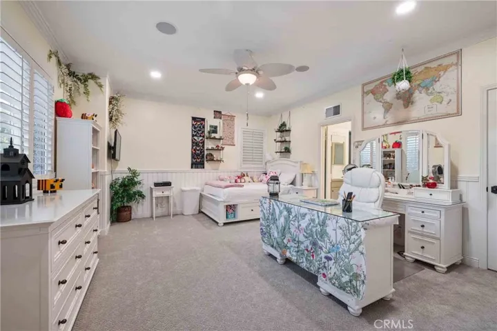 Bedroom upstairs with custom two-tone paint, recessed lights, ceiling fan.