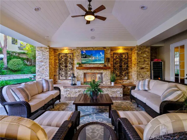 Park like and resort style back yard with California room, electrical fireplace, heaters, travertine ground tiles.