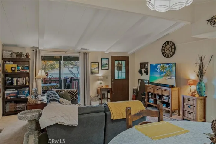 Living room with slider to the deck, vaulted ceilings