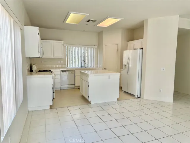 Kitchen opens up to eating and living area