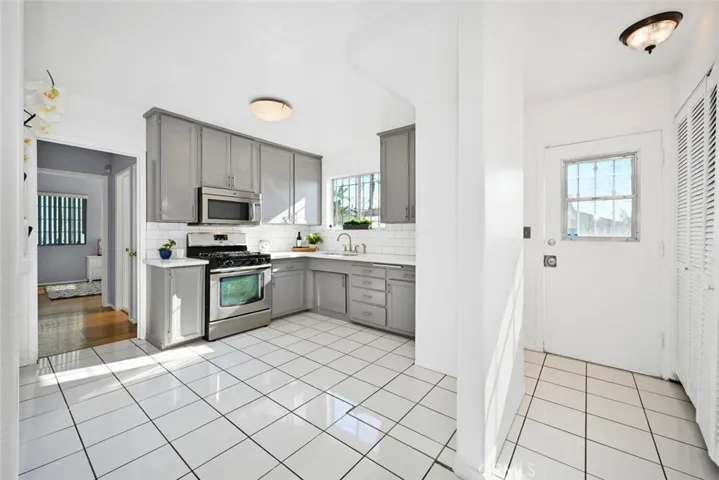 This hallway leads to the backyard; there is inside laundry in this area