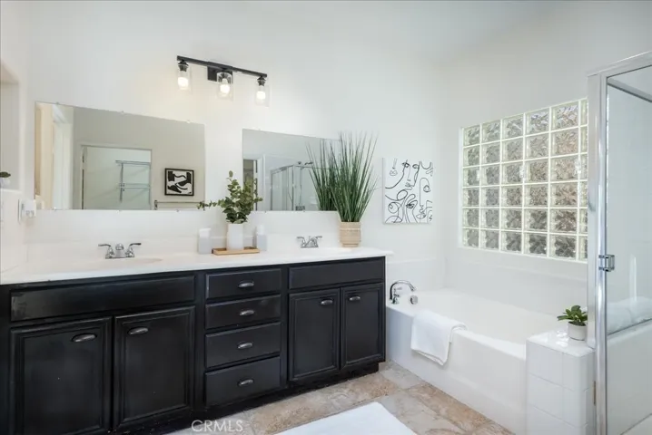 Primary Bedroom En-Suite with double sinks, tub and shower. also leads into a huge walk-in closet.