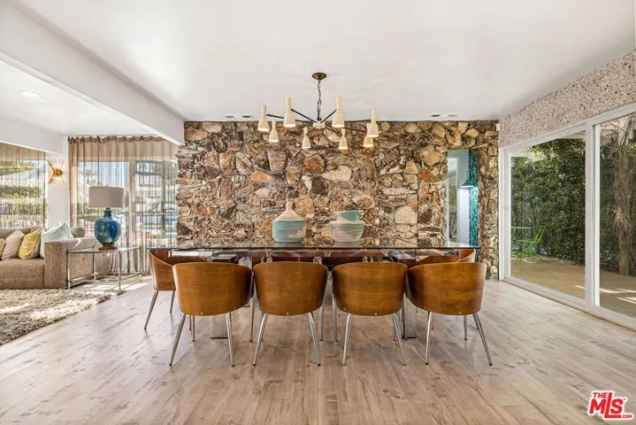 Dining area off great room and kitchen, opening to expansive side patio