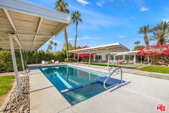 Original steel and aluminum shade panels on both sides of the oversized pool