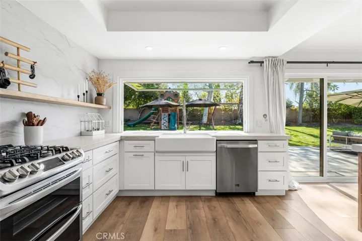 The kitchen has incredible views of the backyard.
