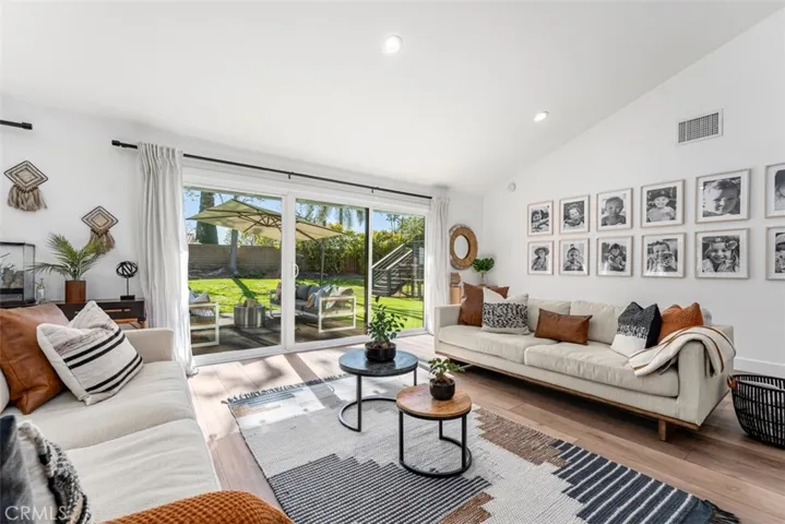 The family room has a fireplace and high ceilings and opens to the backyard.