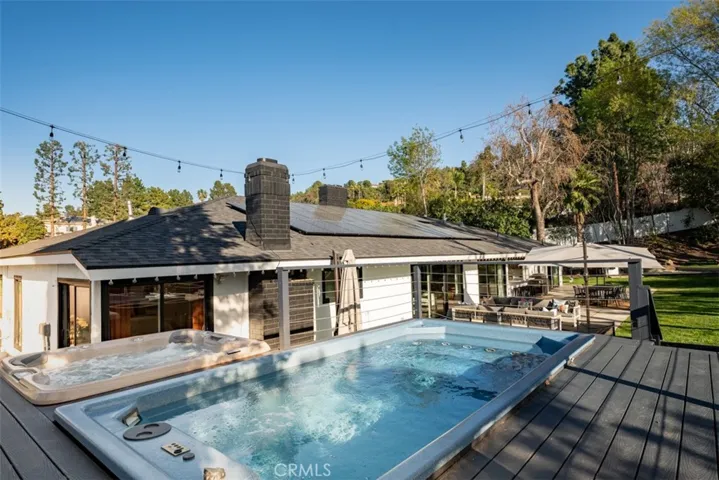This raised deck area features a swim spa and a separate hot tub.