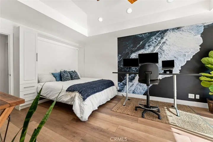 Bedroom #5 is located in a separate wing of the house. It has a built-in murphy shown in the down position.