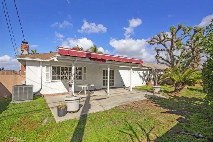 Large Backyard with mature tree, block wall fencing for added privacy & covered patio