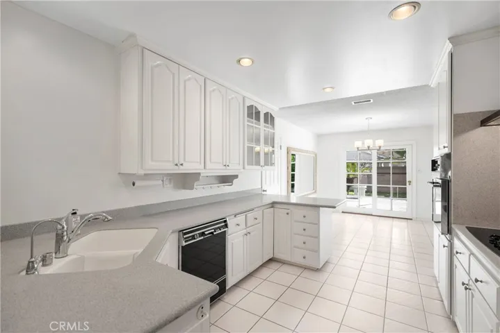 Fabulous kitchen with Built-in appliances & Breakfast Bar overlooking Dining Area & Backyard