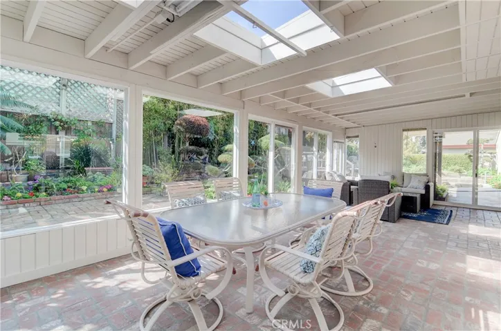 Brick floor in sunroom adds a nice detail to this awesome space.