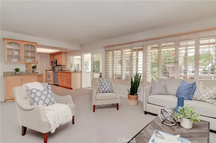 This separate family room is open to the kitchen and has walls of glass to rear yard.
