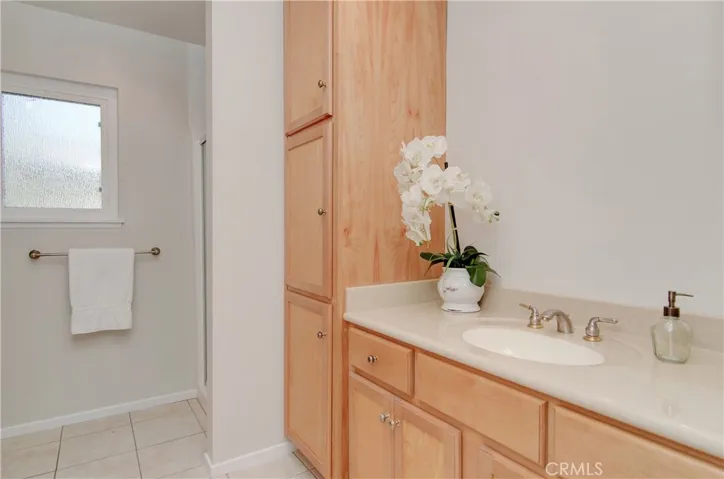 Large downstairs bath has loads of storage and vanity space, plus roomy shower.