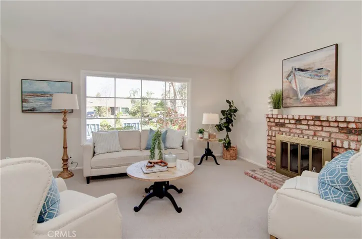 Beautiful details here with giant divided pane window, vaulted ceiling and cozy fireplace.