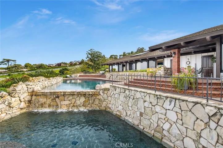 View of the pool w/waterfall into wading pool