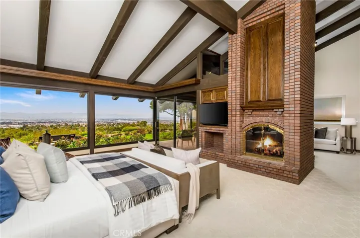 Primary bedroom with view of the fireplace