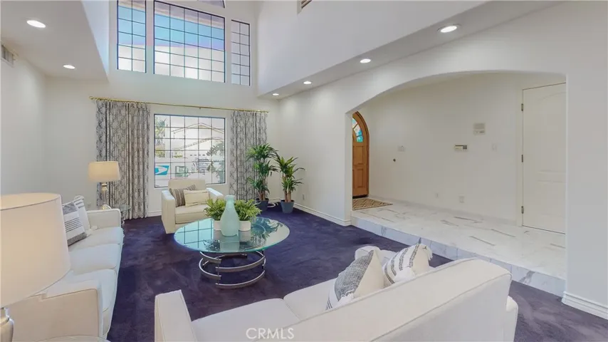 The foyer greets you into the home with elegant marble flooring taking you throughout the first level.