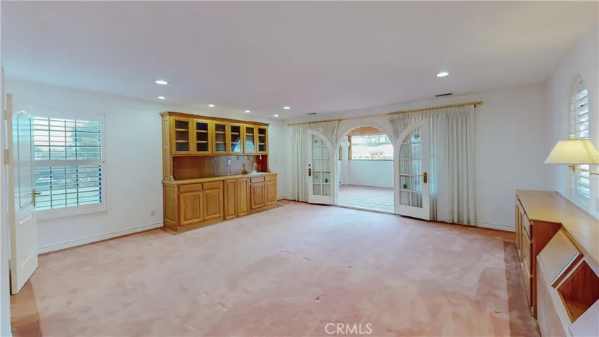 The Primary suite is a luxury getaway with built-in wet bar and headboard and night stands