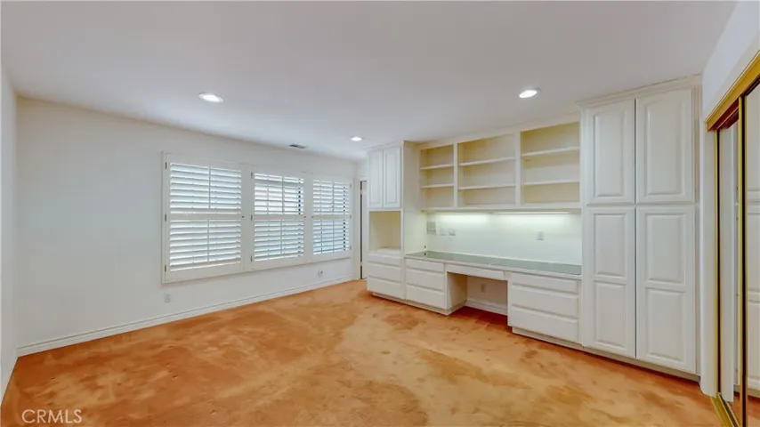 A great option for the students in the family - a quiet bedroom with built-in desk and cabinetry