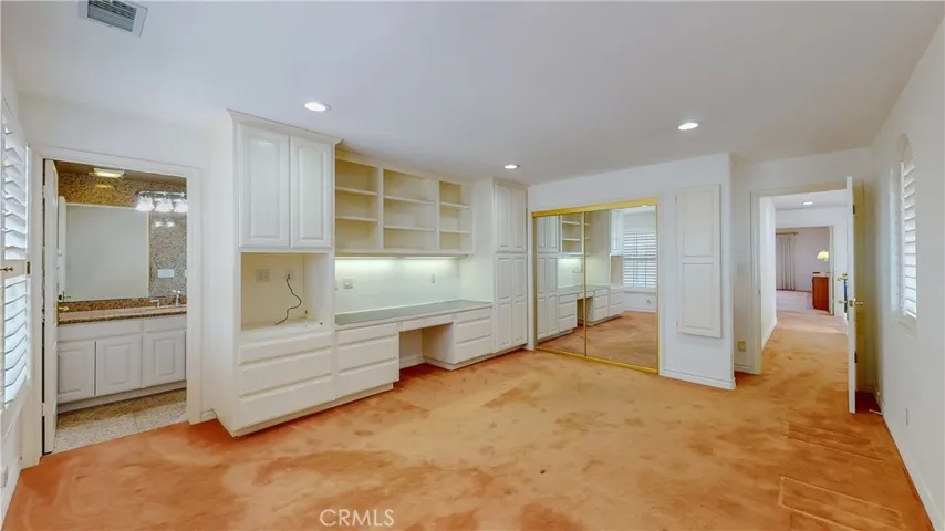 This bedroom has its en-suite bath, built-in desk plus a full closet.