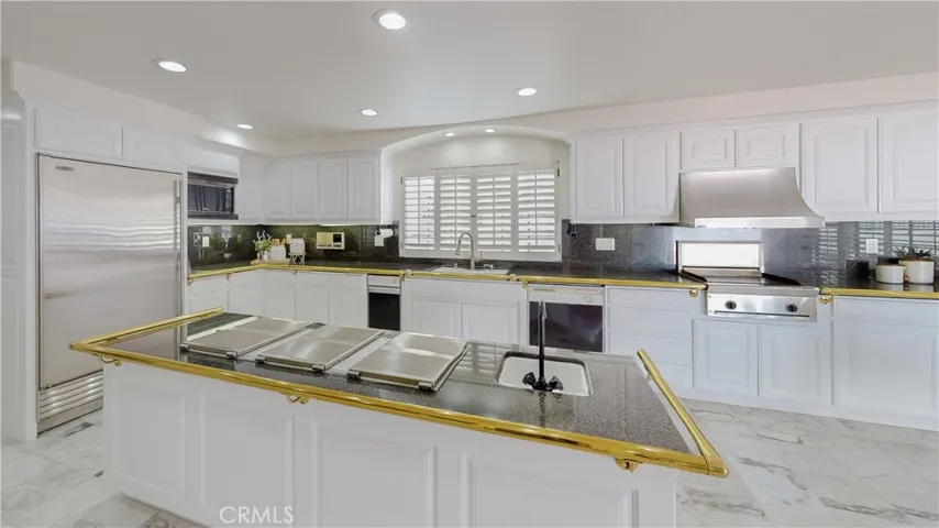 A chef's kitchen for certain...3 Gaggenau gas cooktops, Thermador indoor griddle, a SubZero refrigerator plus a separate freezer, microwave, and plenty of counter space and cabinetry