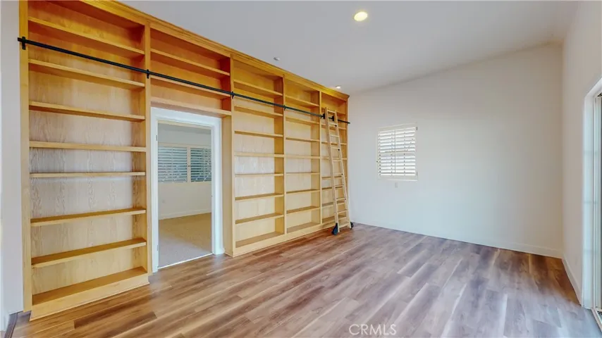 All wall of book shelves in the living room with the entry to the 2nd bedroom in the ADU