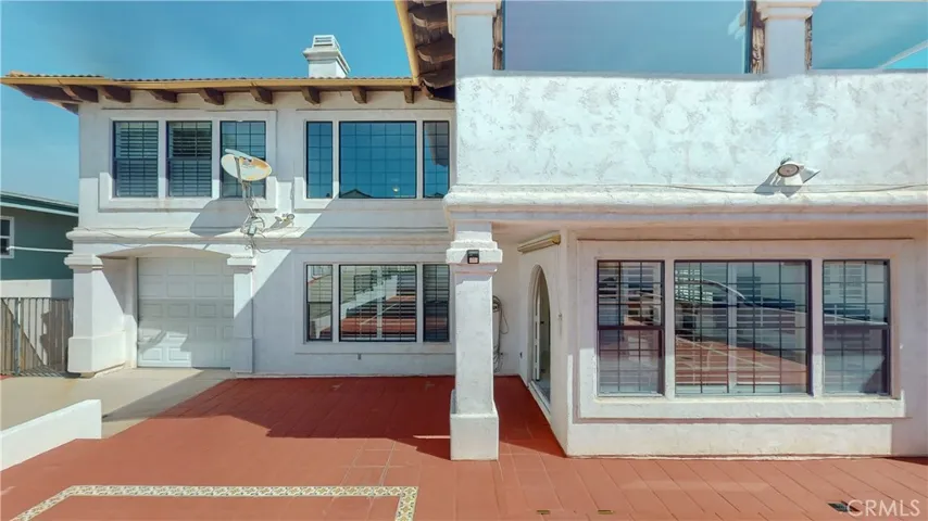 View from gazebo to rear of home and the kitchen and family room windows, along with one of the garages