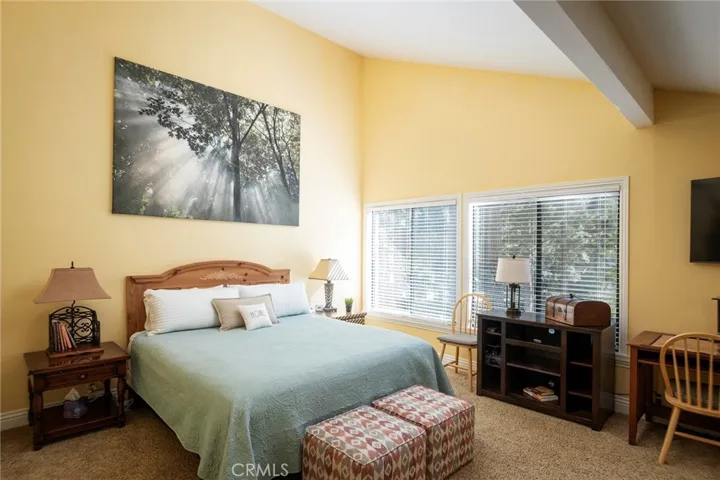 Large master bedroom with vaulted, beamed ceiling