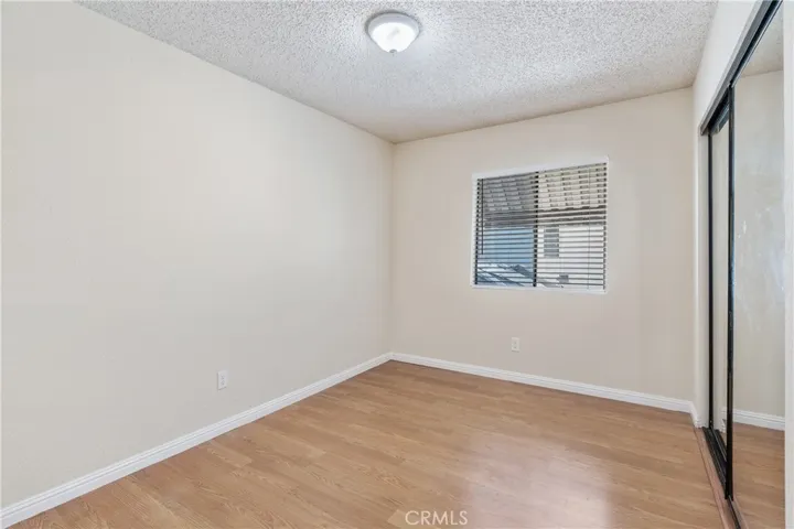 Bedroom with Mirrored Wardrobe Closet